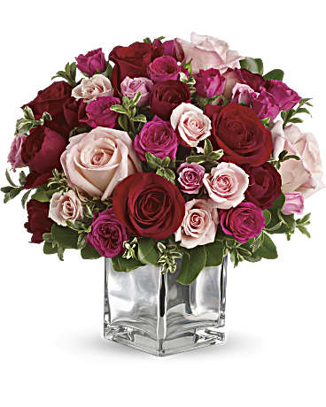 Love Melody bouquet featuring red and pink roses in a clear glass vase, perfect for expressing love.