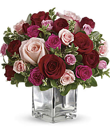 Love Melody bouquet featuring red and pink roses in a clear vase, perfect for expressing love with flowers.